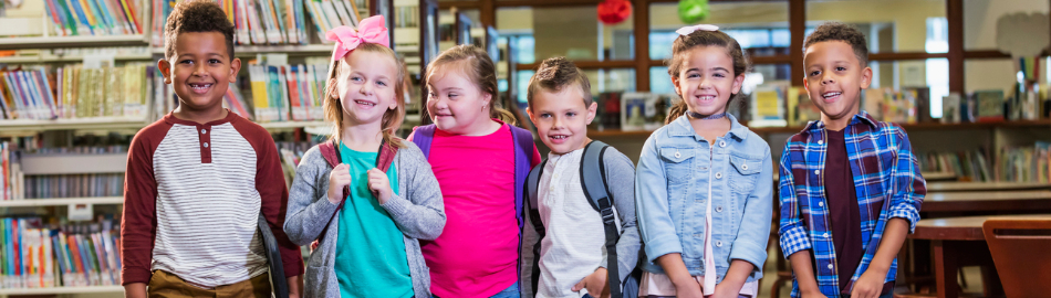 Elementary students together with a downs syndrome student